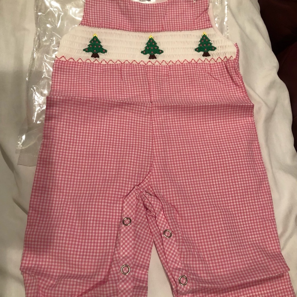 One piece NWT PINK 0-3mo boutique style outfit. Smocked front. Still in plastic.